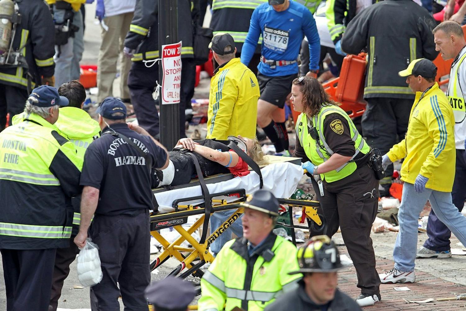 Emergency personnel assist the victims at the scene of a bomb blast during the Boston Marathon in Boston, Massachusetts, Monday, April 15, 2013. (Stuart Cahill/Boston Herald/MCT)