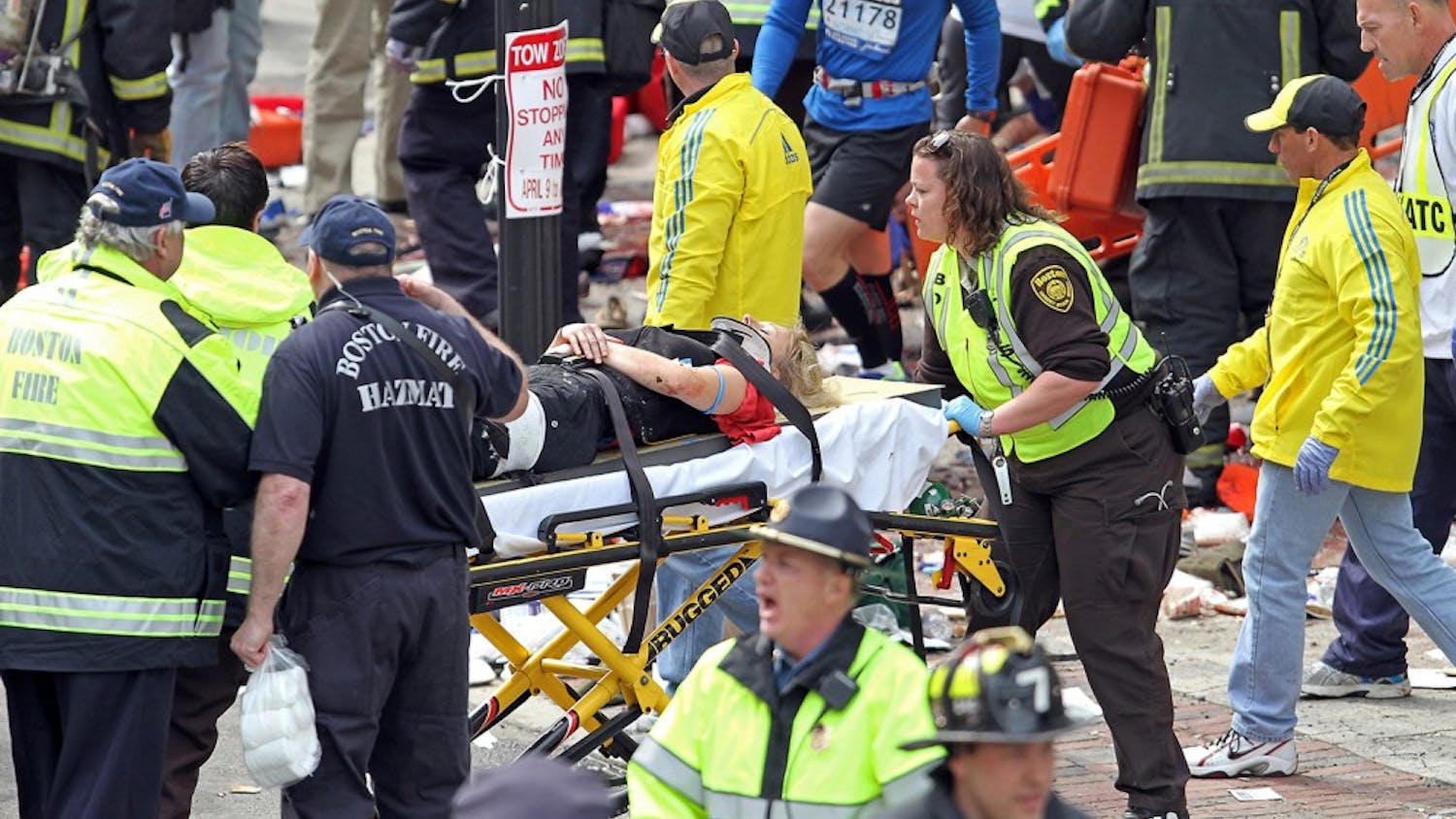 Emergency personnel assist the victims at the scene of a bomb blast during the Boston Marathon in Boston, Massachusetts, Monday, April 15, 2013. (Stuart Cahill/Boston Herald/MCT)