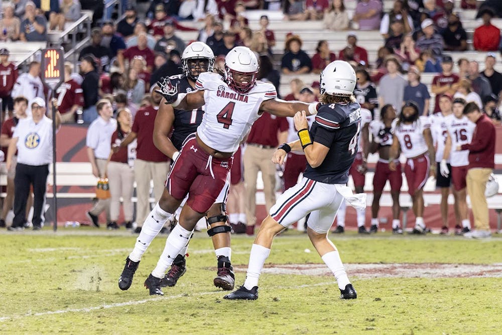 Redshirt junior edge Terrell Dawkins (on left) attempting to block a forward pass from redshirt freshman quarterback Colten Gauthier (on right). The Garnet team won 20-13 at Williams-Brice Stadium on April 17, 2022.