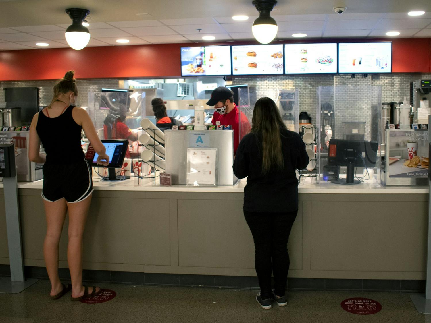 Students order at touch screen monitors at the Chick-fil-A in Russell House.
