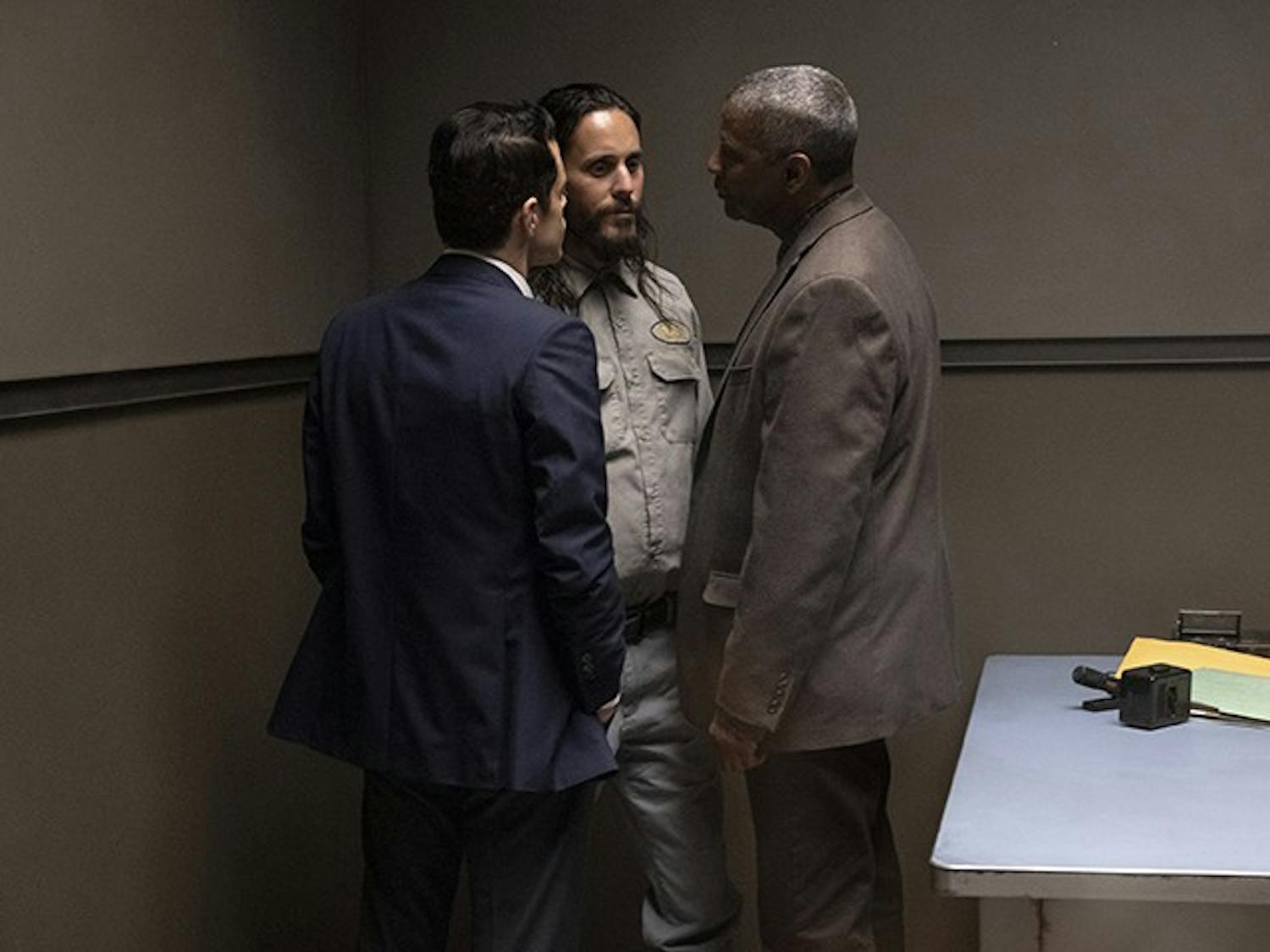Rami Malek, left, Jared Leto, center, and Denzel Washington talk in a scene from "The Little Things".&nbsp;