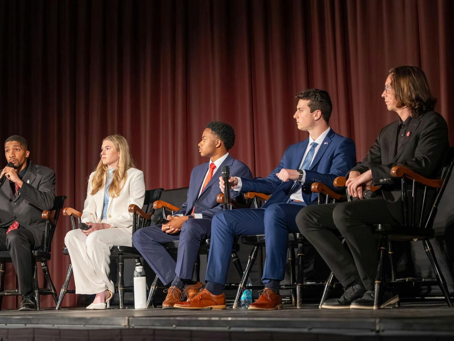 Fourth-year theatre student Bradley Gittens, third-year neuroscience student Emma Strickland, third-year political science student Jordan Cooper, third-year risk management and insurance student Cole Rotondo and doctoral mechanical engineering student Jacob Whisenant sit on a stage in the Russell House Ballroom during the Student Government election debate on Feb. 19, 2026. The elections will take place Feb. 24-25.