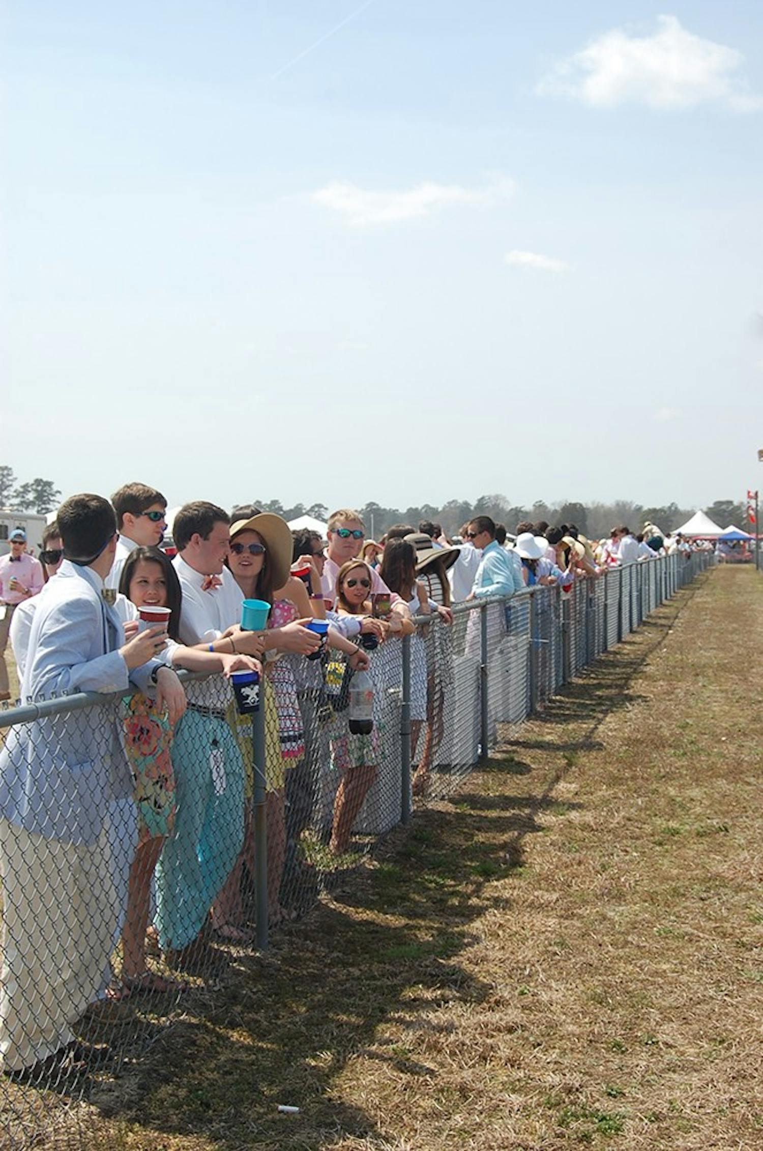 	Spectators made the trek from the tent to the track to watch the horse races.