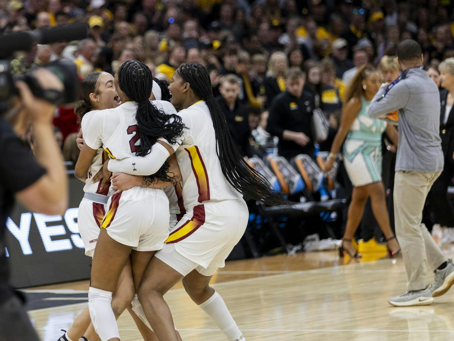 Freshman guard Tessa Johnson, junior guard Bree Hall, senior center Sakima Walker and senior guard Te-Hina Paopao hug in celebration after winning the national championship game. The Gamecocks completed a perfect, undefeated season ending in a national title for the first time in program history.