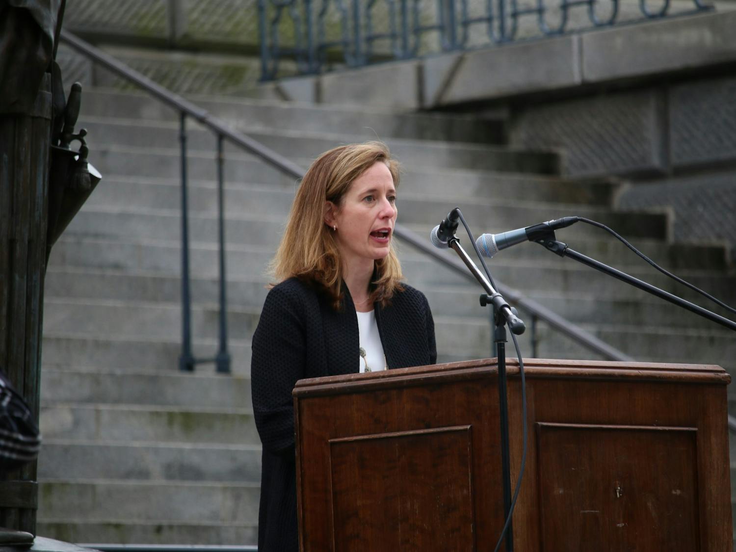 Ann Warner, CEO of Women’s Rights and Empowerment Network (WREN), speaks during Tuesday's protest. WREN was one of the organizations that put together the drive-by “Stop the Ban” protest. 