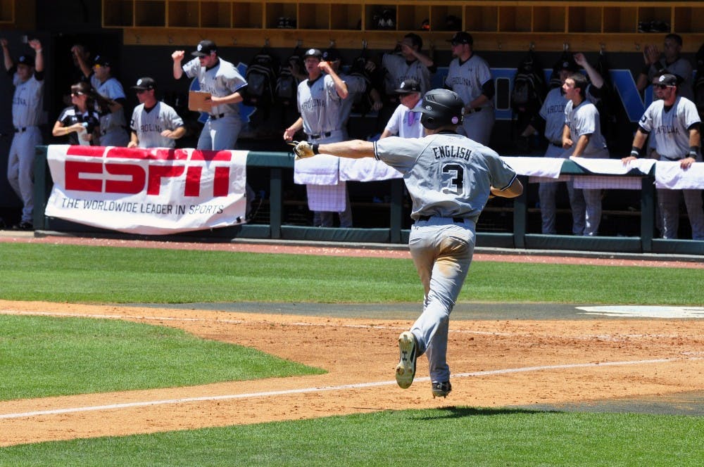 Tanner English celebrates a run as he crosses home plate.