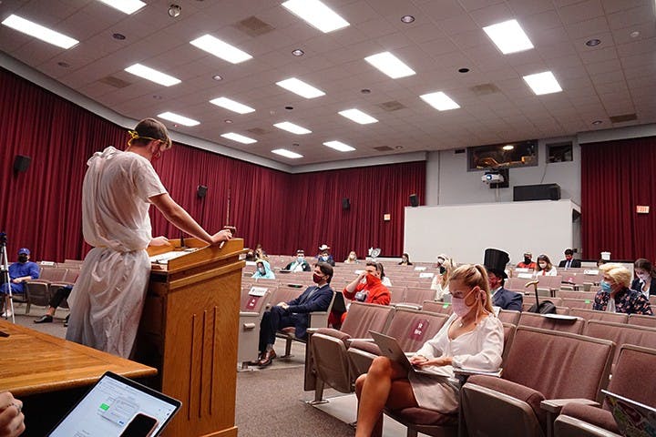 Speaker of the student senate JD Jacobus faces the senate in a toga. Students were encouraged to wear Halloween costumes to the meeting.