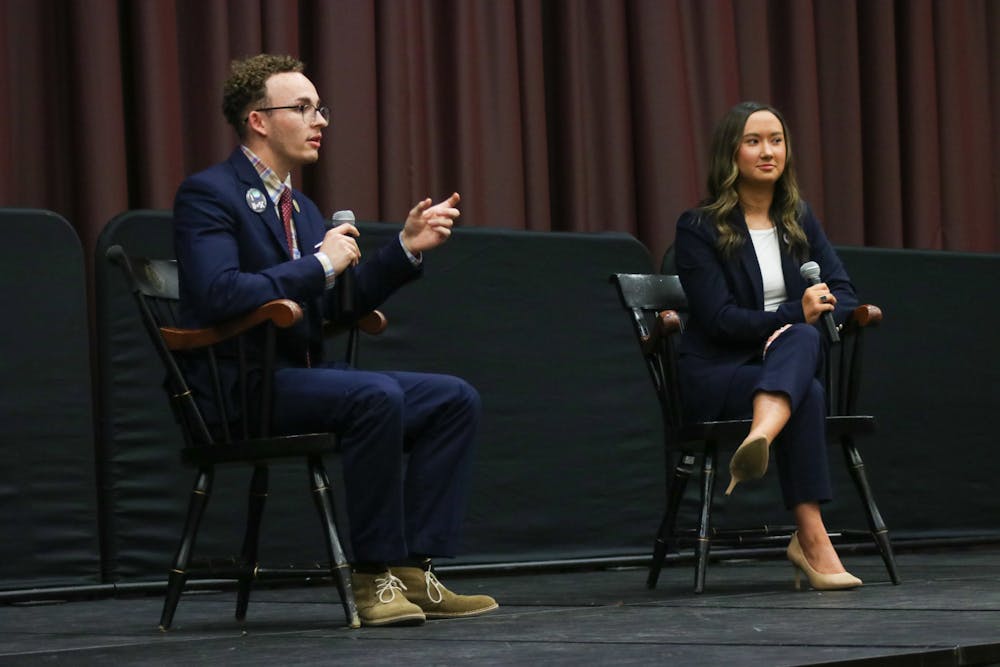 <p>Student body presidential candidates third-year political science student Reilly Arford (left) and third-year public relations student Emily "Emmie" Thompson (right) on stage debating on Feb. 15, 2023. They are the only two presidential candidates this election season.&nbsp;</p>