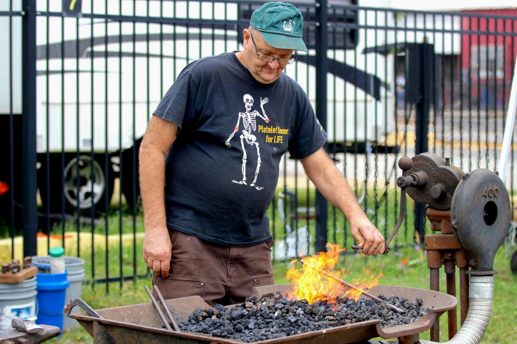 John Tanner heats up metal before checking its temperate to proceed to the next step at the Blacksmith Exhibition at the South Carolina State Fair on Oct. 10, 2025. Tanner is a member of the Philip Simmons Blacksmith Guild.