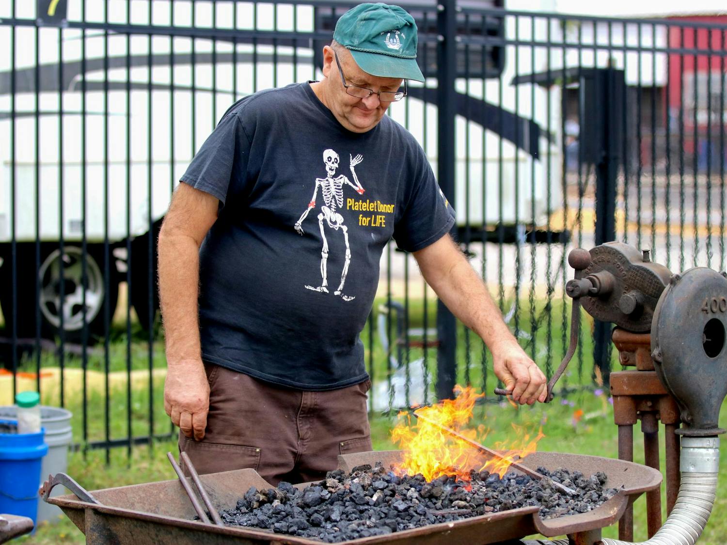 John Tanner heats up metal before checking its temperate to proceed to the next step at the Blacksmith Exhibition at the South Carolina State Fair on Oct. 10, 2025. Tanner is a member of the Philip Simmons Blacksmith Guild.