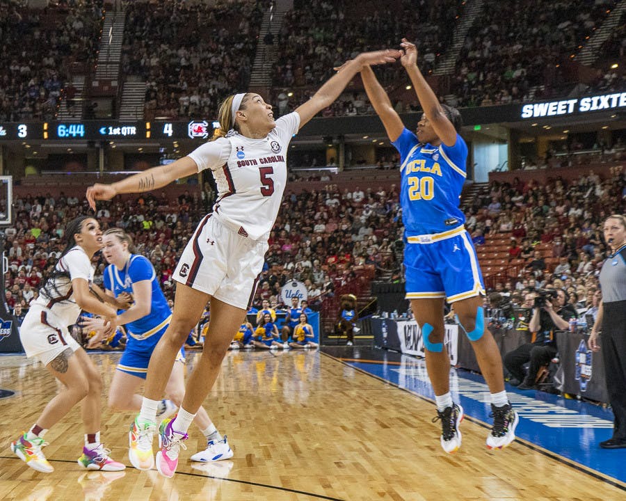 Senior forward Victaria Saxton attempts to block UCLA senior guard Charisma Osbourne's 3-point shot during the matchup between South Carolina and UCLA at Bon Secours Wellness Arena on March 25, 2023. The Gamecocks beat the Bruins 59-43 and will move on to the Elite Eight tournament.&nbsp;