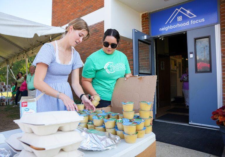Two women at Furman University hand out food to students and community members after Hurricane Helene.