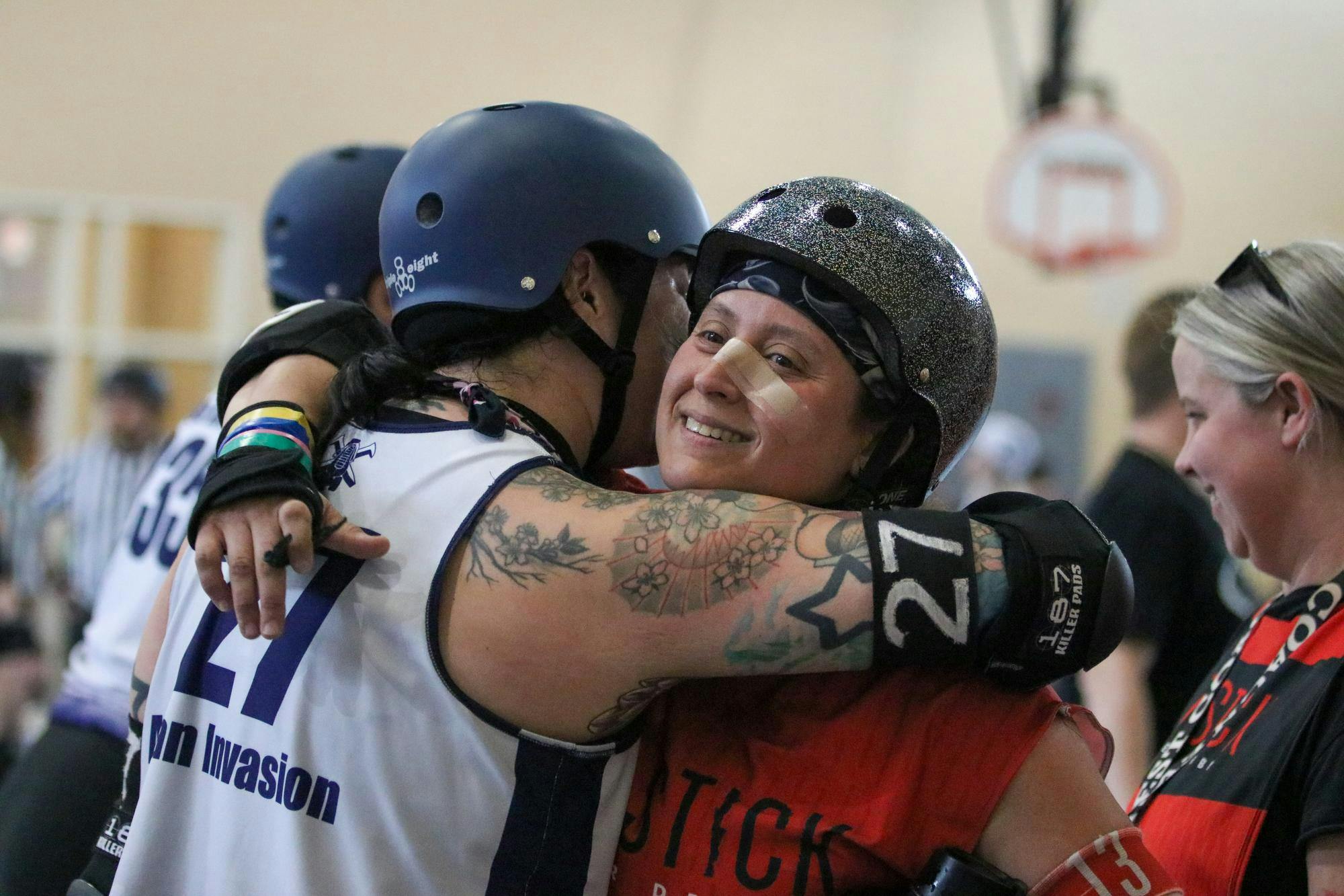 Red Stick All Star skater Jamie “BashHer Boze” Sclafani hugs a Chattanooga All Star skater during an intermission for their match for March Badness at St. Andrews Park on March 21, 2026. Roller derby is a sport open to anyone of any identity, shape and skill level. “Roller derby means everything. It’s more than just a hobby,” Sclafani said. “It’s a family. It’s a community.”