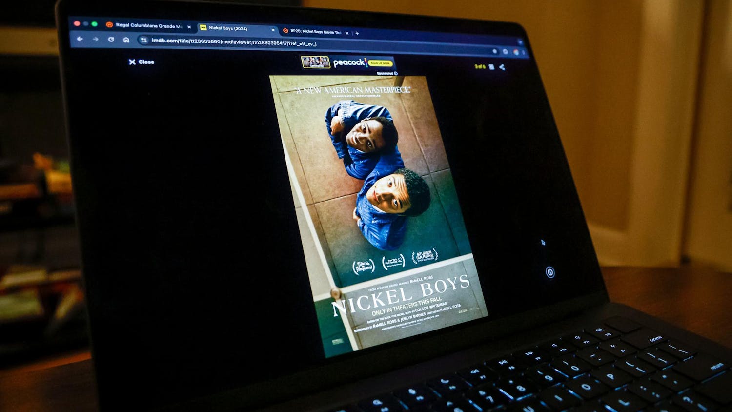 A computer screen displays the poster for the movie "Nickel Boys". The movie tells the story of two African-American boys who are sent to an abusive reform school in 1960s Florida.