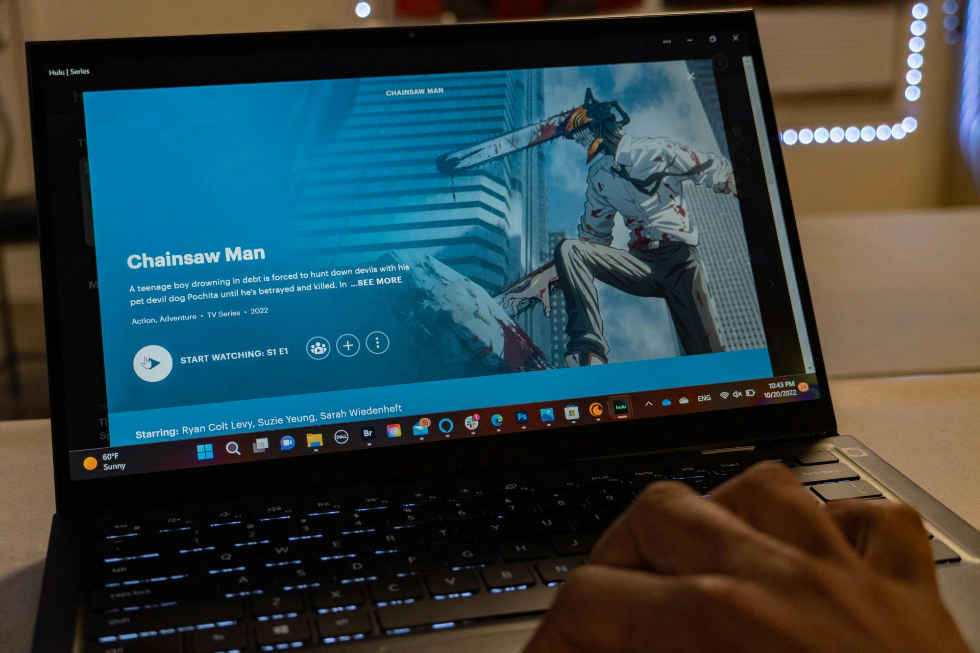 PHOTO ILLUSTRATION: A man watches Chainsaw man on a dell computer on Oct. 20. 2022. &nbsp;The show follows Denji, a poor, simple boy who lives in a world where people’s fears can manifest in the form of devils. &nbsp;&nbsp;