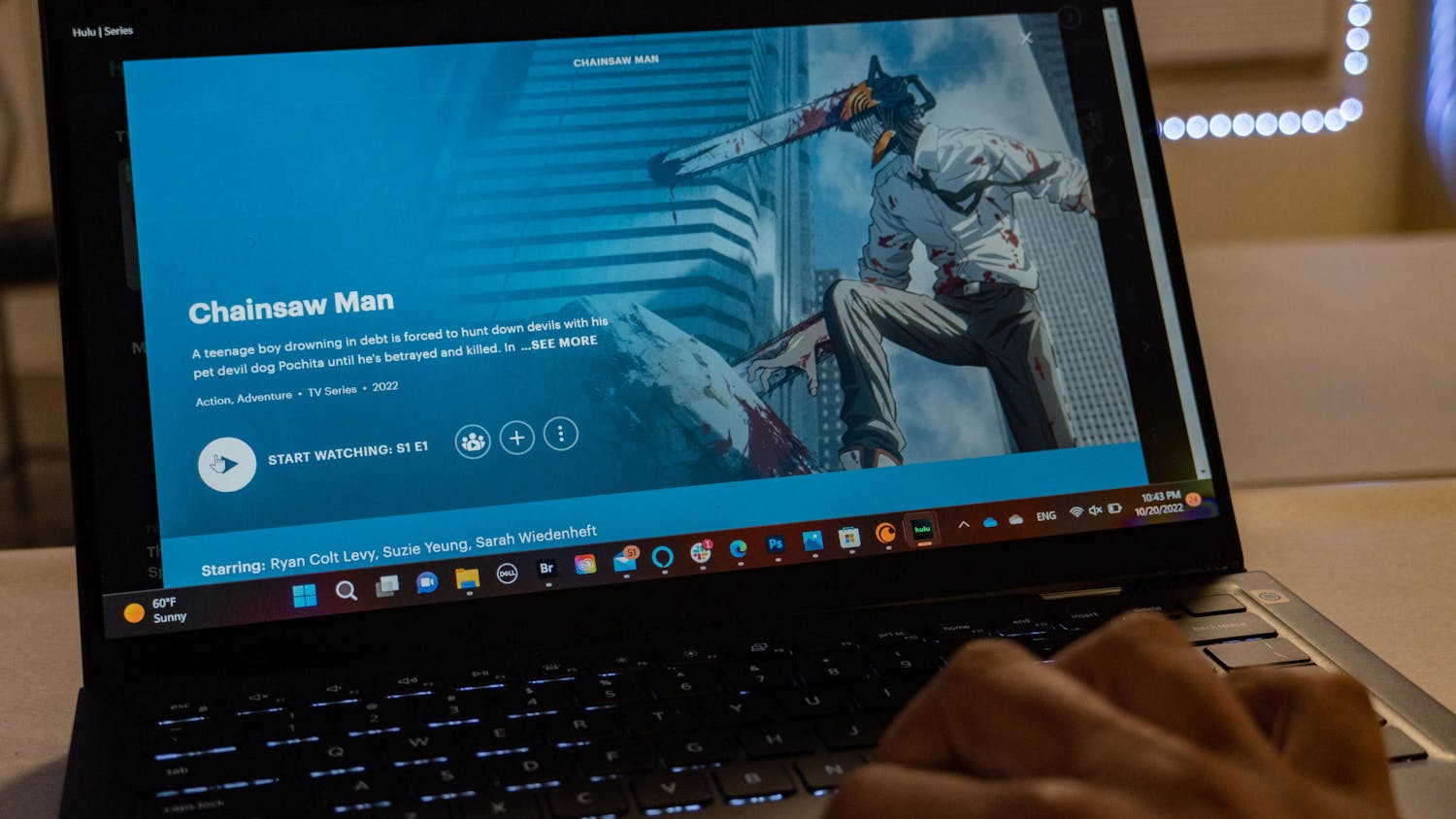 PHOTO ILLUSTRATION: A man watches Chainsaw man on a dell computer on Oct. 20. 2022. &nbsp;The show follows Denji, a poor, simple boy who lives in a world where people’s fears can manifest in the form of devils. &nbsp;&nbsp;