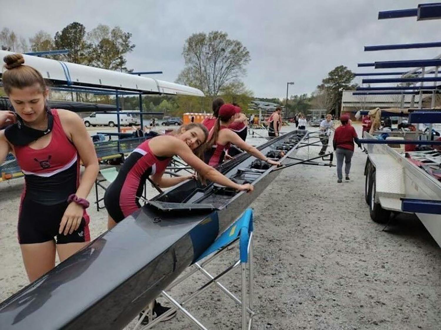 Junior Hannah Skerkis, senior Gabby Ricche, and freshman Alex Defalco preparing their boat for the Women's Novice Four. The Gamecock Rowing Club took to the water at the Clemson Regatta in Clemson, S.C. on April 1, 2022.