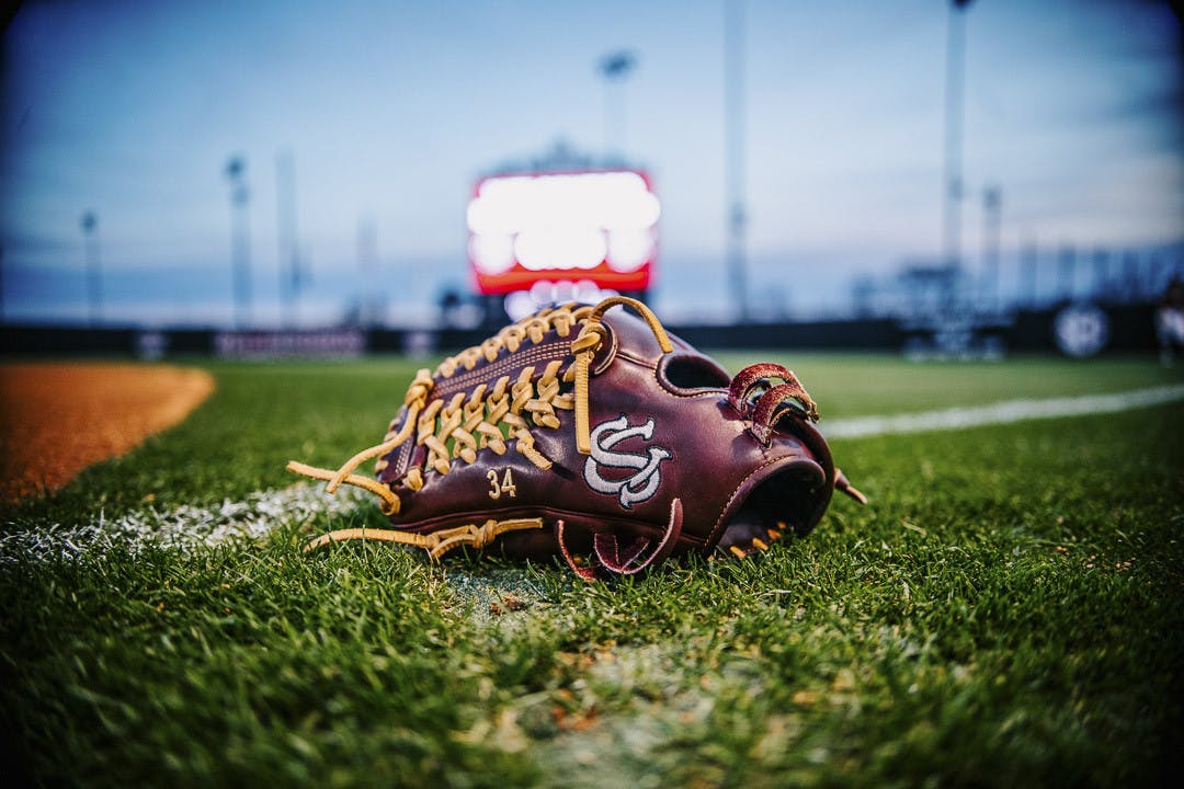 Fifth-year pitcher Rachel Vaughan’s glove sits on the freshly mowed grass at Beckham Field during the matchup between South Carolina and the College of Charleston on February 15, 2023. The Gamecocks beat the Cougars 8-0. 