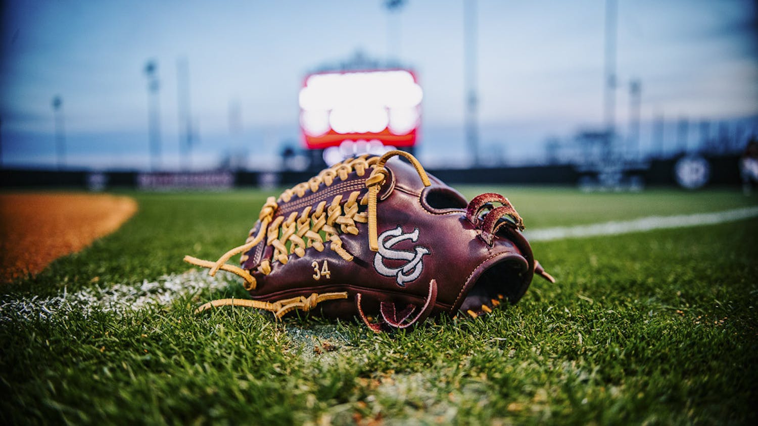 Fifth-year pitcher Rachel Vaughan’s glove sits on the freshly mowed grass at Beckham Field during the matchup between South Carolina and the College of Charleston on February 15, 2023. The Gamecocks beat the Cougars 8-0. 
