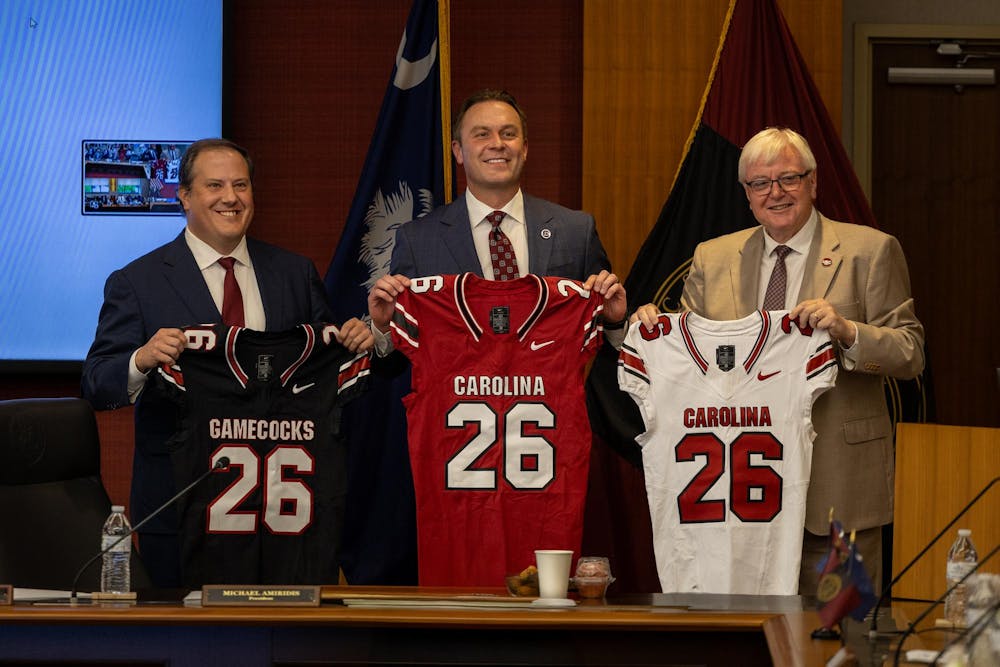 <p>From left to right, board of trustees Chair Thad H. Westbrook, Athletics Director Jeremiah Donati and University President Michael Amiridis, hold up Nike football jerseys at a board of trustees meeting on Aug. 22, 2025. The board of trustees approved a new 10-year apparel contract with Nike, which will start on July 1, 2026.</p>