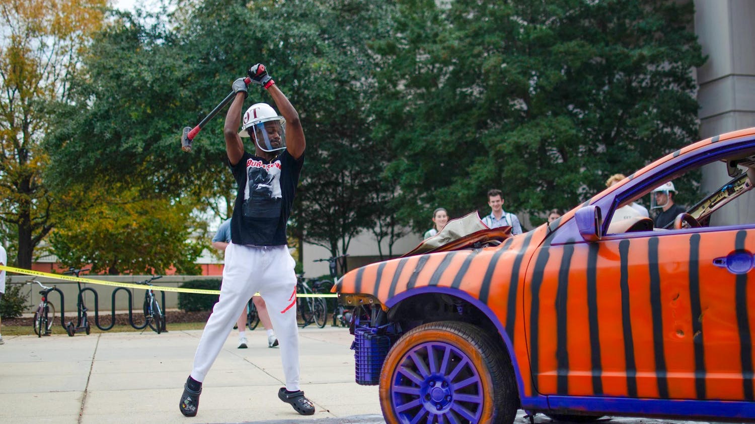 Fourth-year mechanical engineering student Dylon Smith prepares to smash the hood of the Clemson car outside the Swearingen Engineering Center on Nov. 19, 2025. Smith later fully knocked off the hood of the car.