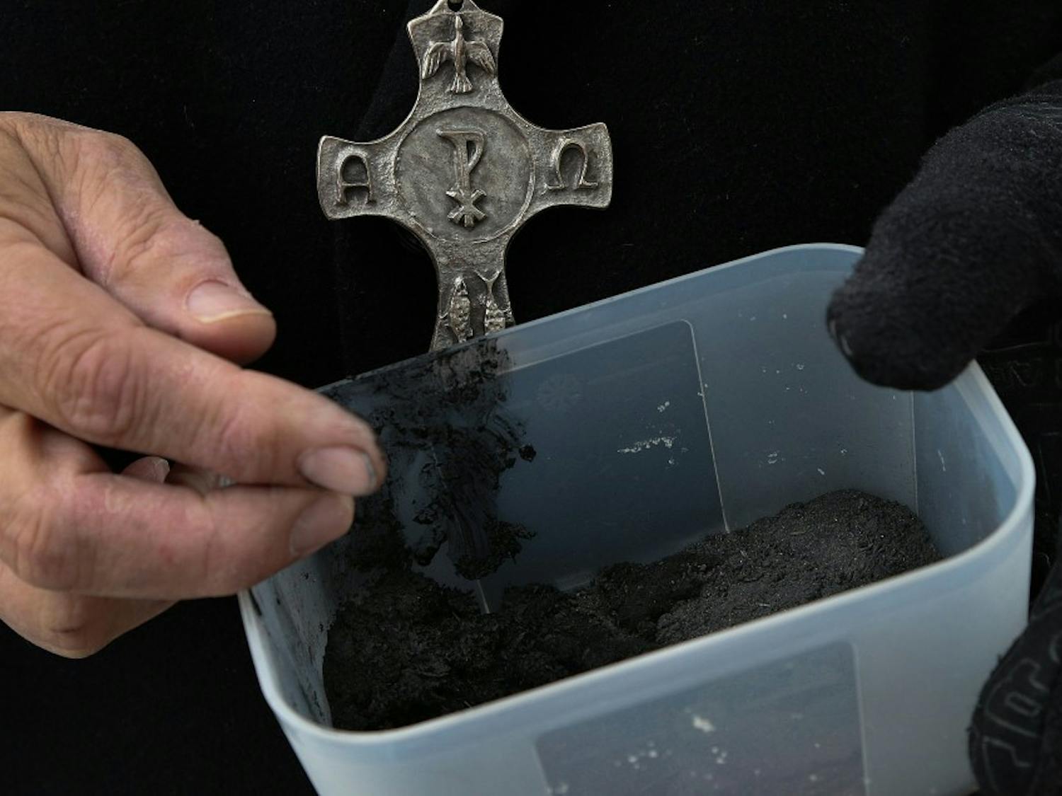 Pastor David Anderson of Greene Street United Methodist Church waits outside the church with palm ashes to offer to students and passersby on March 5, 2014. (Tracy Glantz/The State/MCT)