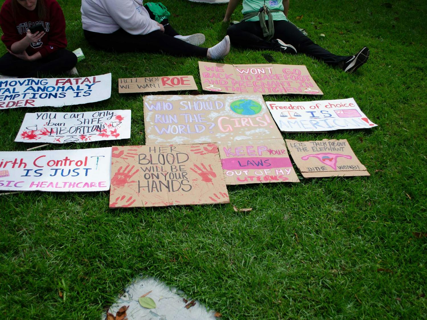 A collection of signs in support of abortion rights lie on the ground at the South Carolina State Capitol on Oct. 1, 2025.