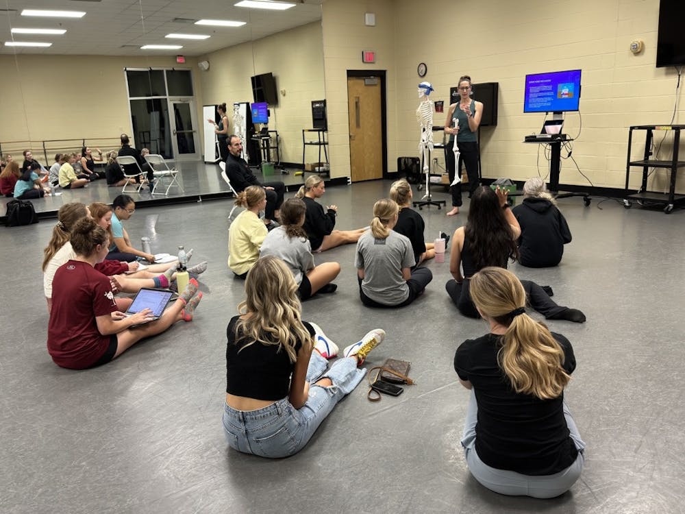 Members of the Carolina Dance and Science club listen intently to Jennifer Deckert’s presentation on knee rotation on Sept. 27, 2022.