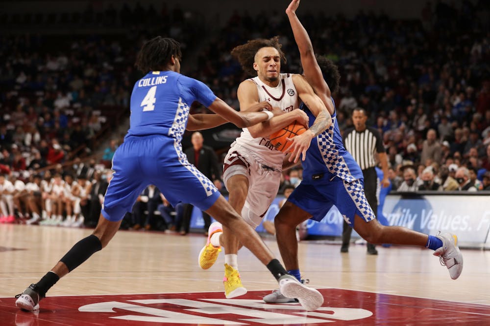 <p>Freshman guard Devin Carter tries to maintain possession amongst the Kentucky defense on Feb. 8, 2022 at Colonial Life Arena. South Carolina lost to Kentucky 86-76.</p>
