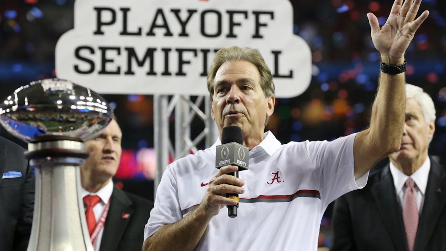 Alabama head coach Nick Saban is presented the trophy after a 24-7 victory against Washington in the Peach Bowl at the Georgia Dome in Atlanta on Saturday, Dec. 31, 2016. (Curtis Compton/Atlanta Journal-Constitution/TNS)