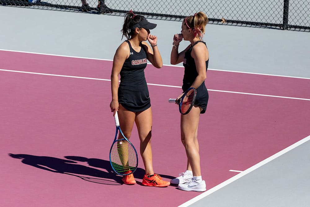 South Carolina’s freshmen Misa Malkin and Sarah Hamner plan their next move during their doubles match against Clemson on Sunday, Feb. 20, 2022. Gamecock’s Women’s Tennis team won 4-2.