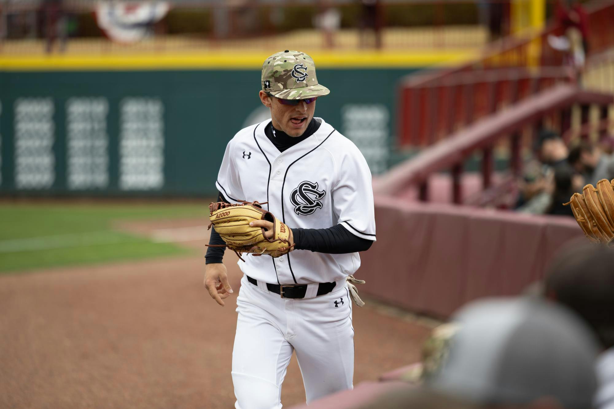 Senior outfielder Evan Stone returns to the dugout after handing young Gamecock fans a fly ball in Founder's Park on Feb. 16, 2025 to celebrate a Gamecock home run. The Gamecocks celebrated a 8-0 win against Sacred Heart during opening weekend 2025.