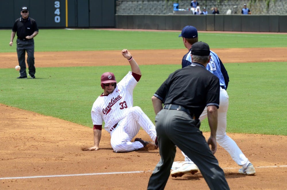 Gamecocks first baseman Kyle Martin slide into third.