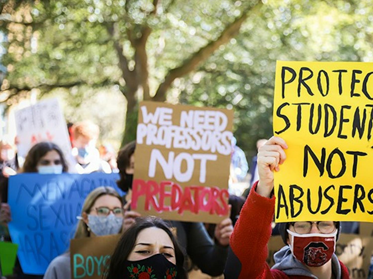 &nbsp;A marching protest attendee holds a sign that has the quote “PROTECT STUDENTS NOT ABUSERS” written on it as they march towards President Caslen’s house.&nbsp;