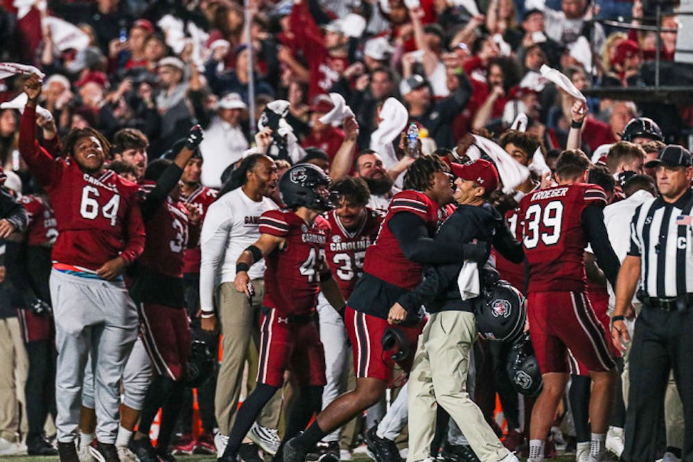 Head coach Shane Beamer gets a hug from freshman defensive lineman D’Andre Martin after the Gamecocks score against the Texas A&M Aggies at Williams-Brice Stadium on Oct. 23, 2022.