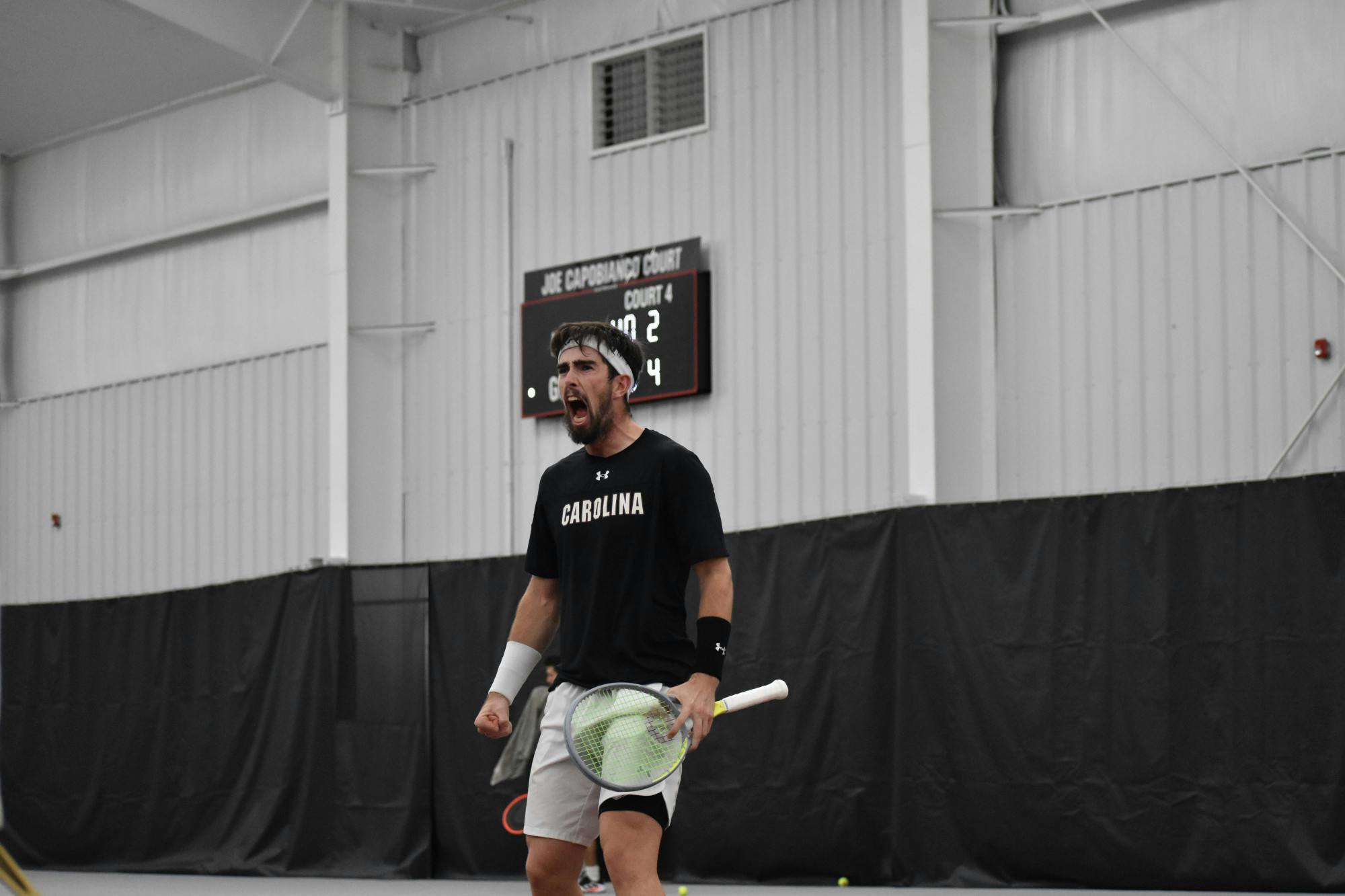 Junior Connor Thomson yells out to the crowd in celebration after winning a set in his singles match on day two of the ITA Kickoff Weekend event at the Carolina Indoor Tennis Center on Jan. 29, 2023. The South Carolina Gamecocks beat N.C. State 4-0, making it the winner of the ITA tournament.&nbsp;