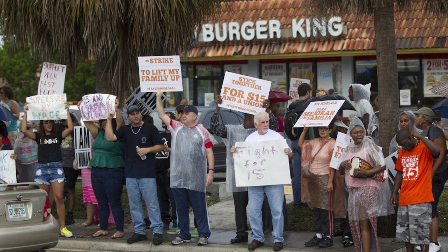 Striking fast food workers hold picket signs as they walk the line in front of restaurants where they picketed during a nationwide protest in favor of a $15/hour minimum wage Sept. 4, 2014 in Miami. In a recent survey, Floridians said they thought minimum wage should be higher. (C.W. Griffin/Miami Herald/TNS) 