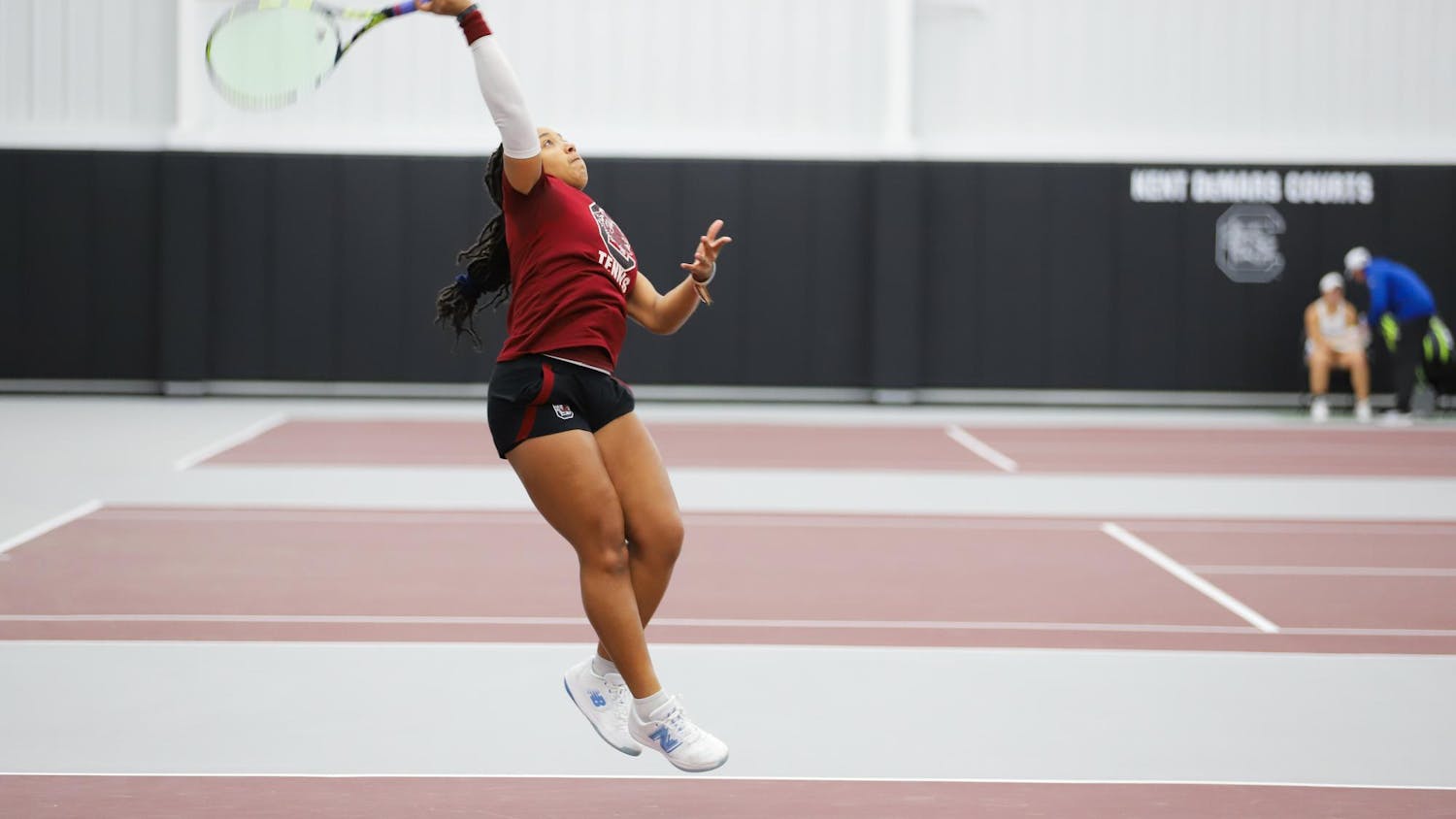 Graduate student Ayana Akli jumps to hit an incoming ball on Jan. 21, 2024, at the Carolina Indoor Tennis Center. Akli played in both singles and doubles matches against Presbyterian.