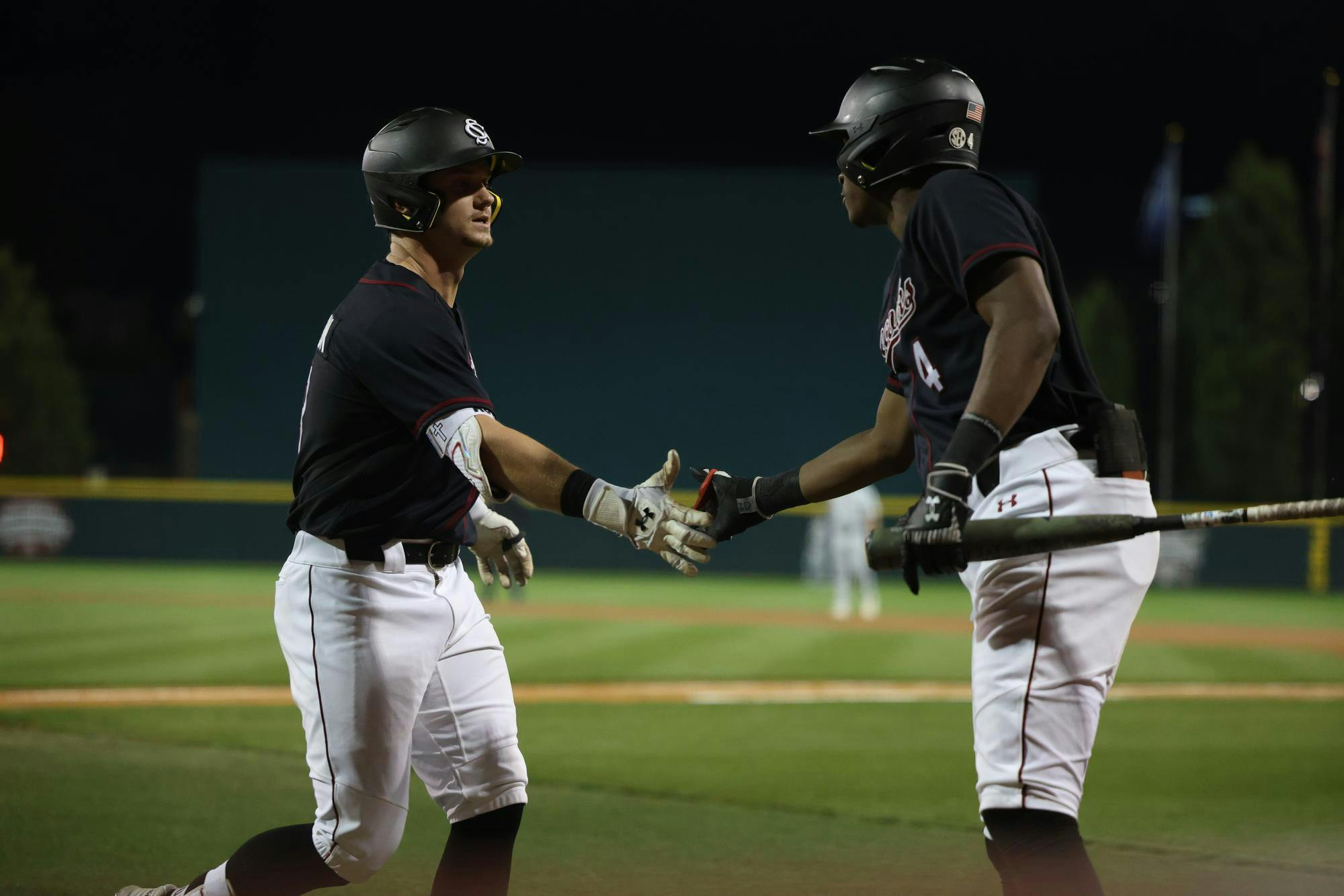 Sophomore infielder Erik Parker congratulates junior outfielder Aaron Jamison at home plate after Jamison launched a home run during South Carolina’s March 4 matchup against Charleston Southern at Founders Park. The Gamecocks won 4-1 against the Buccaneers.