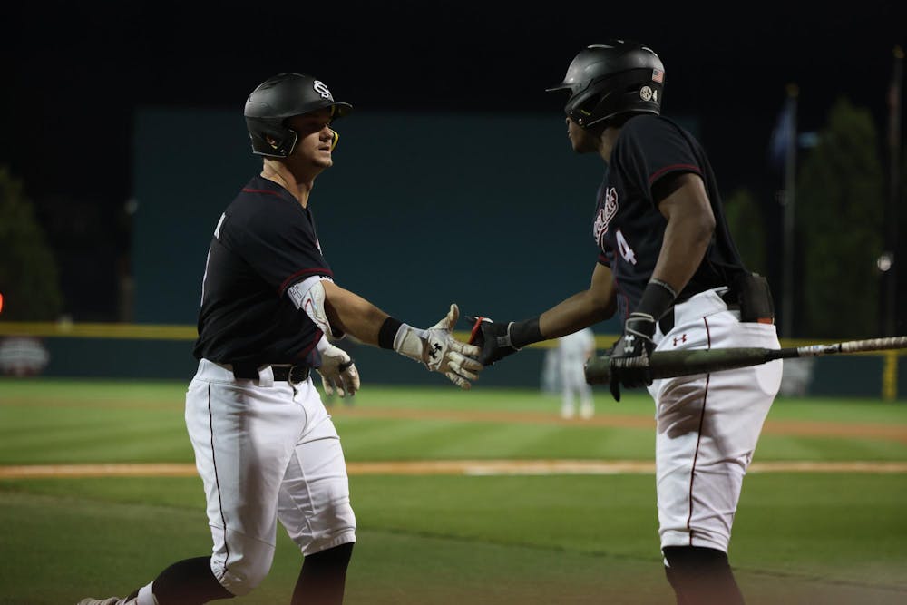 <p>Sophomore infielder Erik Parker congratulates junior outfielder Aaron Jamison at home plate after Jamison launched a home run during South Carolina’s March 4 matchup against Charleston Southern at Founders Park. The Gamecocks won 4-1 against the Buccaneers.</p>