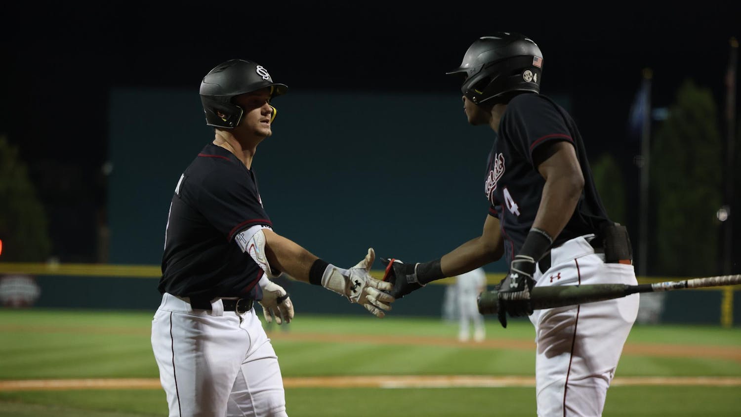 Sophomore infielder Erik Parker congratulates junior outfielder Aaron Jamison at home plate after Jamison launched a home run during South Carolina’s March 4 matchup against Charleston Southern at Founders Park. The Gamecocks won 4-1 against the Buccaneers.