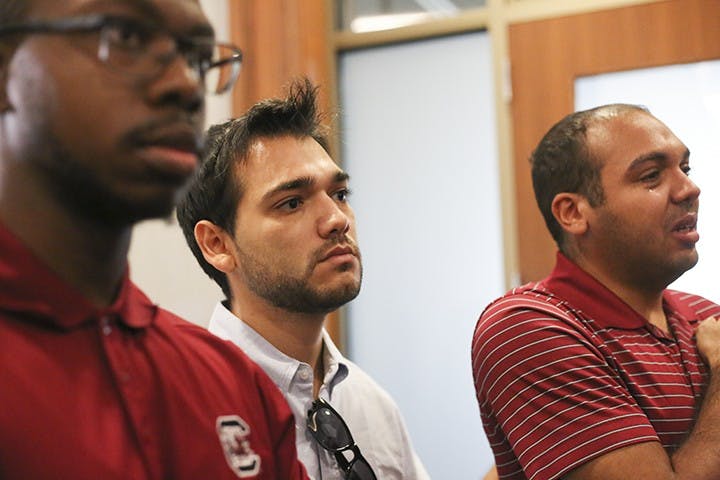 Protestors stand in silent shock following the selection of Gen. Robert Caslen as USC's next president.&nbsp;
