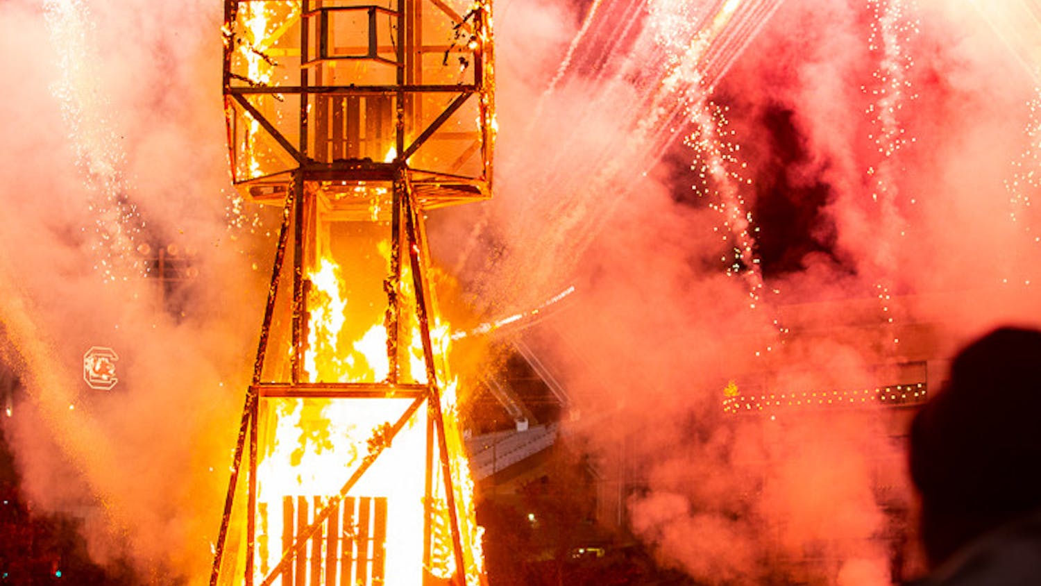 The Clemson Tiger statue was set ablaze during the Tiger Burning ceremony and within five minutes was nearly entirely burnt. The firework show rages on in the background as the crowd cheers.