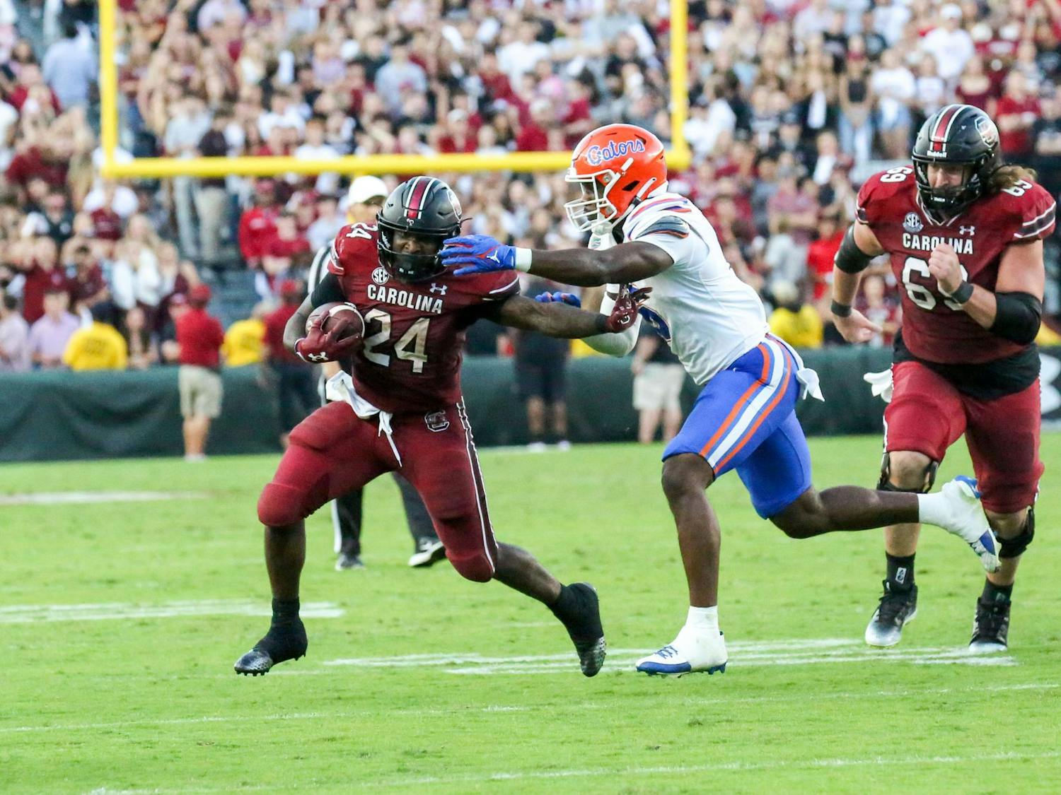Redshirt senior running back Mario Anderson stiff arms a Gator defender during South Carolina’s game against Florida on Oct. 14, 2023, at Williams-Brice Stadium. With 98 rushing yards and 23 receiving yards, Anderson had his second consecutive game with more than 100 all-purpose yards.