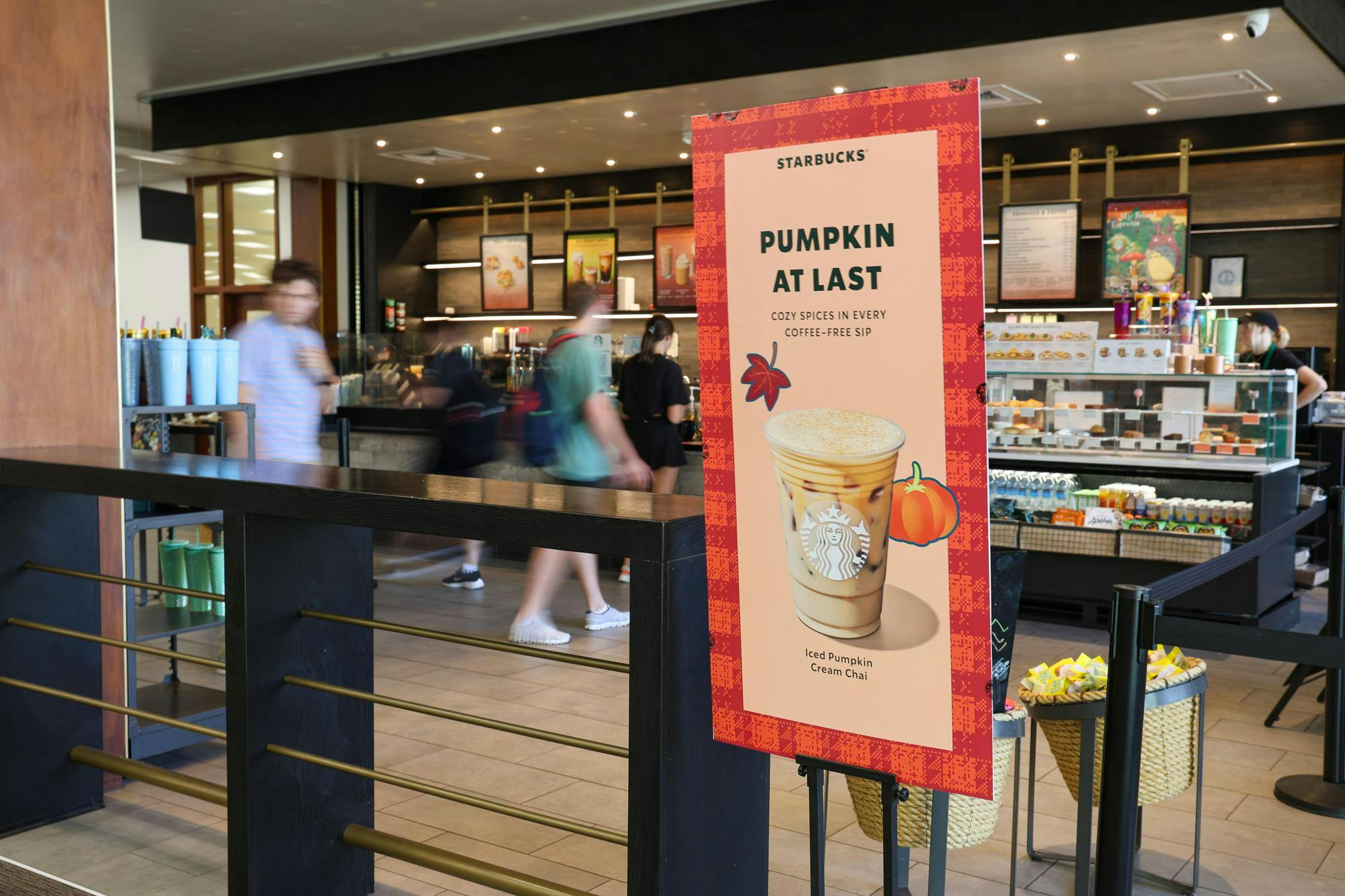 A sign reading "Pumpkin at Last" with an iced pumpkin cream chai inside the Thomas Cooper Library Starbucks on Sept. 4, 2024. Starbucks rolled out its fall flavors at the end of August, and they will be available until November.