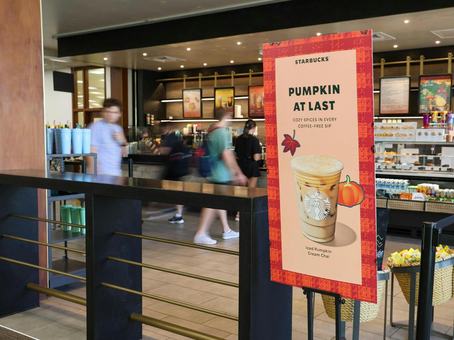 A sign reading "Pumpkin at Last" with an iced pumpkin cream chai inside the Thomas Cooper Library Starbucks on Sept. 4, 2024. Starbucks rolled out its fall flavors at the end of August, and they will be available until November.