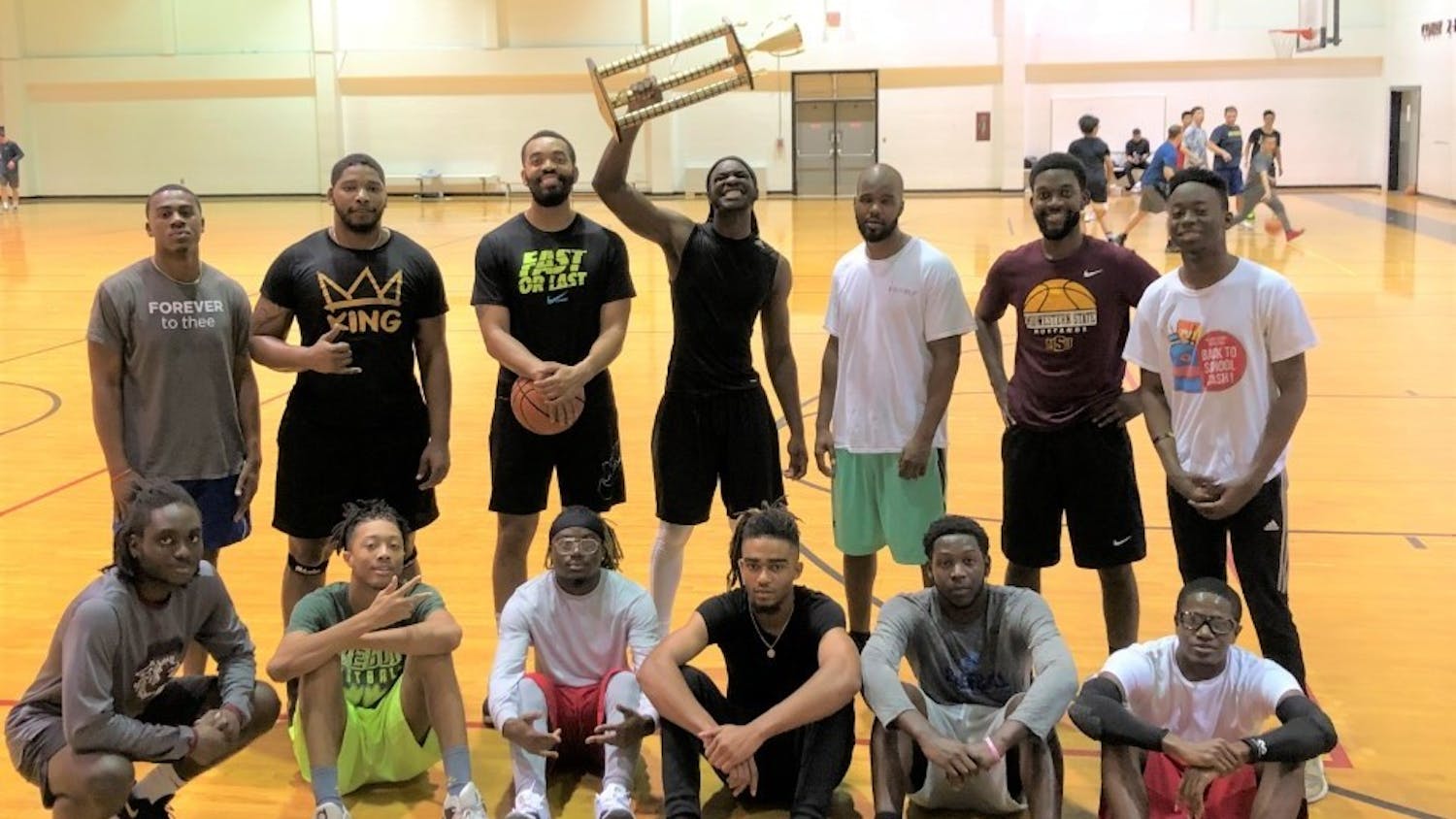 Students and mentors celebrate after the B2B student basketball tournament.&nbsp;