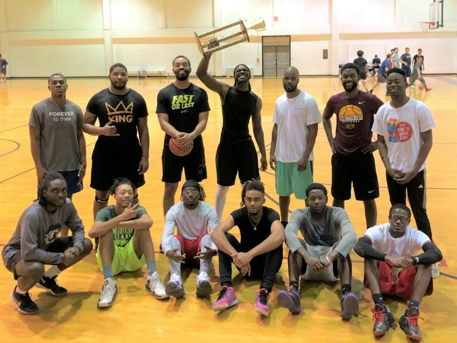 Students and mentors celebrate after the B2B student basketball tournament. 