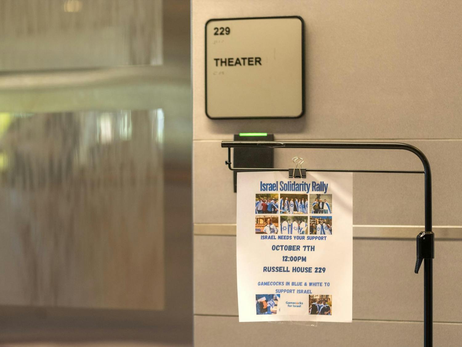A flyer for the Israel Solidarity Rally hangs outside the Russell House Theater on the day of the rally, Oct. 7, 2024. Police officers were stationed in the area to protect attendees during the two-hour rally.