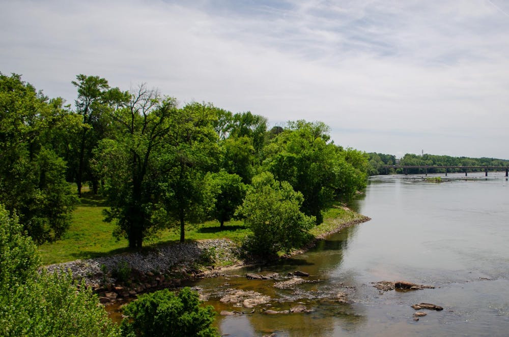 <p>A large, undeveloped section of land by the Congaree River is seen from the Gervais Street bridge on April 13, 2026. The area, currently fenced off, is planned to be developed into a public park.</p>